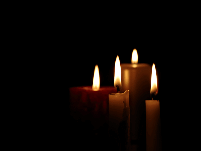Lit candles in the dark