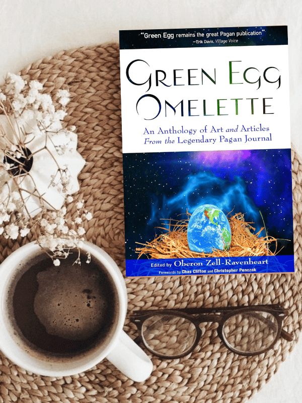 Green Egg Omelette book next to flowers and a cup of coffee.