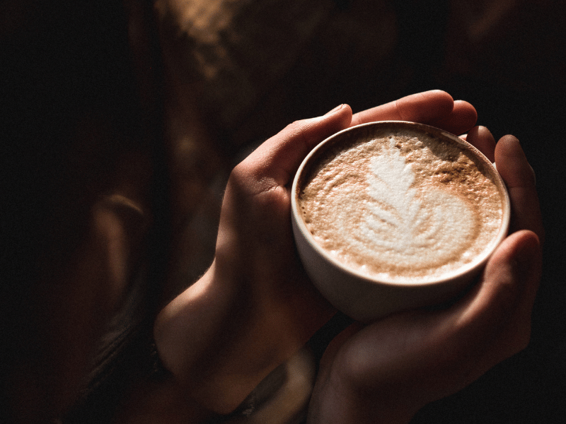 Hands holding a cup of coffee.
