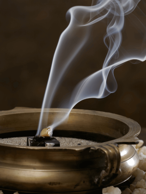 Frankincense incense burning in a brass bowl.
